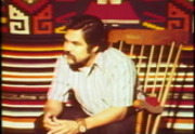 Playwright Luis Vladez, sitting on chair