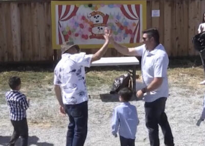 Two adults giving high five to each other